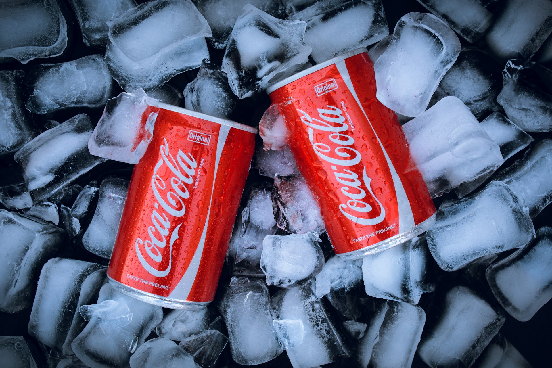 Coca-Cola cans on ice cubes. Image credit: Unsplash, free license